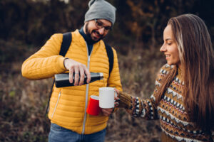 A couple in love, take a break from hiking with tea