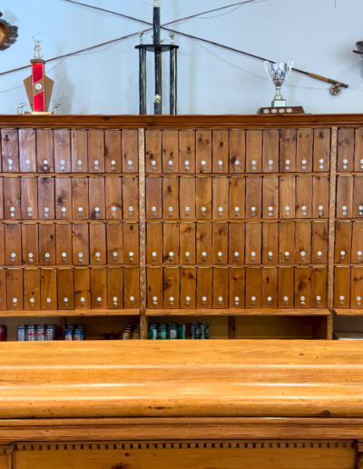 A row of polished wooden personalized liquor lockers inside the clubhouse.